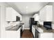 Bright kitchen featuring granite countertops, stainless steel appliances and white cabinets at 3251 Oak Lake Pl # 135, Winter Park, FL 32792