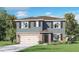 Charming two-story home with stone accents, shutters, attached garage, and lush landscaping at 33609 Seattle Slew Dr, Sorrento, FL 32776
