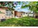 Lush backyard with well-maintained lawn, brick patio, and partial shade from trees at 3416 Gerber Daisy Ln, Oviedo, FL 32766