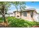 Backyard showcasing lush green grass, exterior of home, and partial privacy fence at 3416 Gerber Daisy Ln, Oviedo, FL 32766