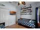 Comfortable bedroom with blue accent walls and a decorative display shelf at 3416 Gerber Daisy Ln, Oviedo, FL 32766