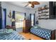 Bright bedroom featuring two twin beds, nautical décor, and wood laminate flooring at 3416 Gerber Daisy Ln, Oviedo, FL 32766
