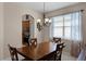 Elegant dining area featuring a wood table and a view into the kitchen at 3416 Gerber Daisy Ln, Oviedo, FL 32766