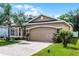Charming single-Gathering home with a two-car garage, well-maintained lawn, and inviting curb appeal at 3416 Gerber Daisy Ln, Oviedo, FL 32766