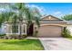 Charming single-story home featuring a well-maintained lawn and a two-car garage at 3416 Gerber Daisy Ln, Oviedo, FL 32766