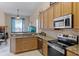 Functional kitchen with stainless steel appliances, granite counters, and breakfast bar at 3416 Gerber Daisy Ln, Oviedo, FL 32766