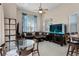 Bright living room with a large aquarium, tile flooring, and comfortable seating area at 3416 Gerber Daisy Ln, Oviedo, FL 32766