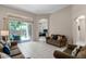 Bright living room with tile flooring, neutral walls, and backyard access at 3416 Gerber Daisy Ln, Oviedo, FL 32766