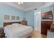 Spacious main bedroom with light blue walls, wood floors, king bed, and walk-in closet access at 3416 Gerber Daisy Ln, Oviedo, FL 32766
