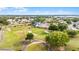 Scenic aerial view of a lush golf course with winding paths and mature trees surrounding a home at 3617 Cherry Hill Dr, Orlando, FL 32822