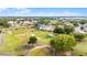 Scenic aerial view of a lush golf course with winding paths and mature trees surrounding homes at 3617 Cherry Hill Dr, Orlando, FL 32822
