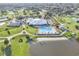 Aerial view of a community clubhouse, pool, golf course, and lake at 3617 Cherry Hill Dr, Orlando, FL 32822