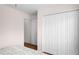 Bedroom features hardwood floors, closet with folding doors, and access to another room at 3617 Cherry Hill Dr, Orlando, FL 32822