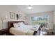 Cozy bedroom featuring a high ceiling, a ceiling fan, and a large window with views of the outside at 3617 Cherry Hill Dr, Orlando, FL 32822