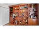 This office space showcases a spacious wooden bookcase with a variety of decorative items and books at 3617 Cherry Hill Dr, Orlando, FL 32822