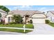 Well-maintained single-story home with a manicured lawn, white trim, and a two-car garage at 3617 Cherry Hill Dr, Orlando, FL 32822