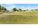 Lush green golf course as viewed from the house, with a blue sky and scattered trees at 3617 Cherry Hill Dr, Orlando, FL 32822