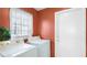 Laundry room featuring a standard washer and dryer, window, and a white door at 3617 Cherry Hill Dr, Orlando, FL 32822