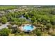 Community pool surrounded by palm trees and native Florida landscaping at 3808 Enchantment Ln, St Cloud, FL 34772