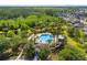 Community pool surrounded by palm trees and native Florida landscaping at 3808 Enchantment Ln, St Cloud, FL 34772