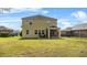 Well-maintained backyard features green grass and a screened-in patio at 3808 Enchantment Ln, St Cloud, FL 34772