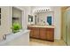 A bright bathroom featuring a double vanity, tile floors, and a glass door shower at 3808 Enchantment Ln, St Cloud, FL 34772