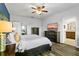 An inviting bedroom with wood floors, a ceiling fan, and an ensuite bathroom at 3808 Enchantment Ln, St Cloud, FL 34772
