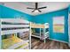 bedroom featuring bunk beds with gray and yellow bedding at 3808 Enchantment Ln, St Cloud, FL 34772