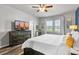 A cozy bedroom featuring a ceiling fan, wood floors, and natural light from a window at 3808 Enchantment Ln, St Cloud, FL 34772