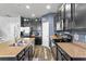 Kitchen area equipped with stainless appliances, granite counters, and dark cabinets at 3808 Enchantment Ln, St Cloud, FL 34772