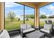Outdoor lanai with seating and a view of the backyard and trees at 3808 Enchantment Ln, St Cloud, FL 34772