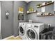 Well-organized laundry room with modern appliances and decorative shelving at 3808 Enchantment Ln, St Cloud, FL 34772