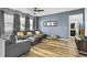 Cozy living room with a comfortable sectional sofa, wood floors, and ample natural light at 3808 Enchantment Ln, St Cloud, FL 34772