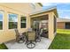 Covered screened in patio features comfortable seating, ideal for relaxation and outdoor dining at 3808 Enchantment Ln, St Cloud, FL 34772