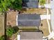 Birds eye view of a fenced back yard, patio and roof of a home with green trees at 428 Winding Oak Ln, Longwood, FL 32750