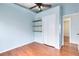 Bright bedroom with hardwood floors, closet, shelving and ceiling fan at 428 Winding Oak Ln, Longwood, FL 32750