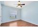 Well-lit bedroom with modern wood floors, a ceiling fan, and a large window at 428 Winding Oak Ln, Longwood, FL 32750