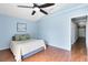 Cozy bedroom with laminated wood floor, a ceiling fan and a bed with blue walls at 428 Winding Oak Ln, Longwood, FL 32750