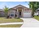 Charming single-story home featuring a well-manicured lawn, a bay window, and an attached garage at 428 Winding Oak Ln, Longwood, FL 32750