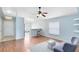 Open-concept living room with wood floors, ceiling fan, and breakfast bar at 428 Winding Oak Ln, Longwood, FL 32750