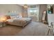 Carpeted bedroom features a wooden bed frame, full length mirror, and a flat screen television on the wall at 4418 Shiva Loop, Kissimmee, FL 34746