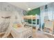 Bright bedroom featuring a bunk bed, a single bed and a custom mural at 4418 Shiva Loop, Kissimmee, FL 34746