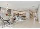 Open dining area with a dining table set for a dinner party, open to the kitchen, and modern finishes at 4418 Shiva Loop, Kissimmee, FL 34746
