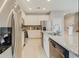 Modern kitchen featuring stainless steel appliances, granite countertops, and white cabinets at 4418 Shiva Loop, Kissimmee, FL 34746