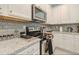 Close up shot of a kitchen featuring modern stainless steel appliances and granite countertops at 4418 Shiva Loop, Kissimmee, FL 34746