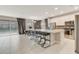 Open concept kitchen featuring a large center island with seating, stainless steel appliances, and tiled floors at 4418 Shiva Loop, Kissimmee, FL 34746