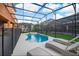 Beautiful in-ground pool, lounge chairs, and covered patio area in backyard of home at 4418 Shiva Loop, Kissimmee, FL 34746
