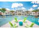 Stunning community pool with modern lounge furniture and shade umbrellas. Exterior clubhouse in the background at 4418 Shiva Loop, Kissimmee, FL 34746