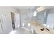 Bright bathroom featuring a glass shower and a double sink vanity for a fresh and modern feel at 4420 Shiva Loop, Kissimmee, FL 34746