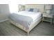 Comfortable bedroom featuring a king-sized bed with stylish blue accents and ample natural light at 4420 Shiva Loop, Kissimmee, FL 34746